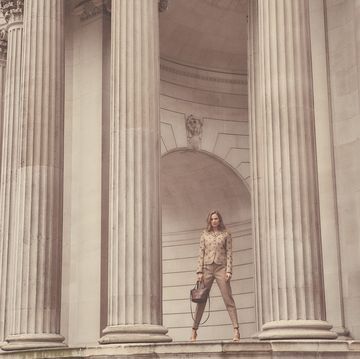 tailored tweeds, timeless trench coats, chic cashmere and supple leather boots this is the sophisticated take on power dressing for modern working women, modelled here by eniko mihalik as she makes her way along threadneedle street to the bank of england, london england eniko wear's, wool jacket, Â£2,915 matching trousers, Â£1,005 leather heels, Â£565 leather bag, Â£1,915, all bottega veneta, standing, holding bag in right hand, looking forward